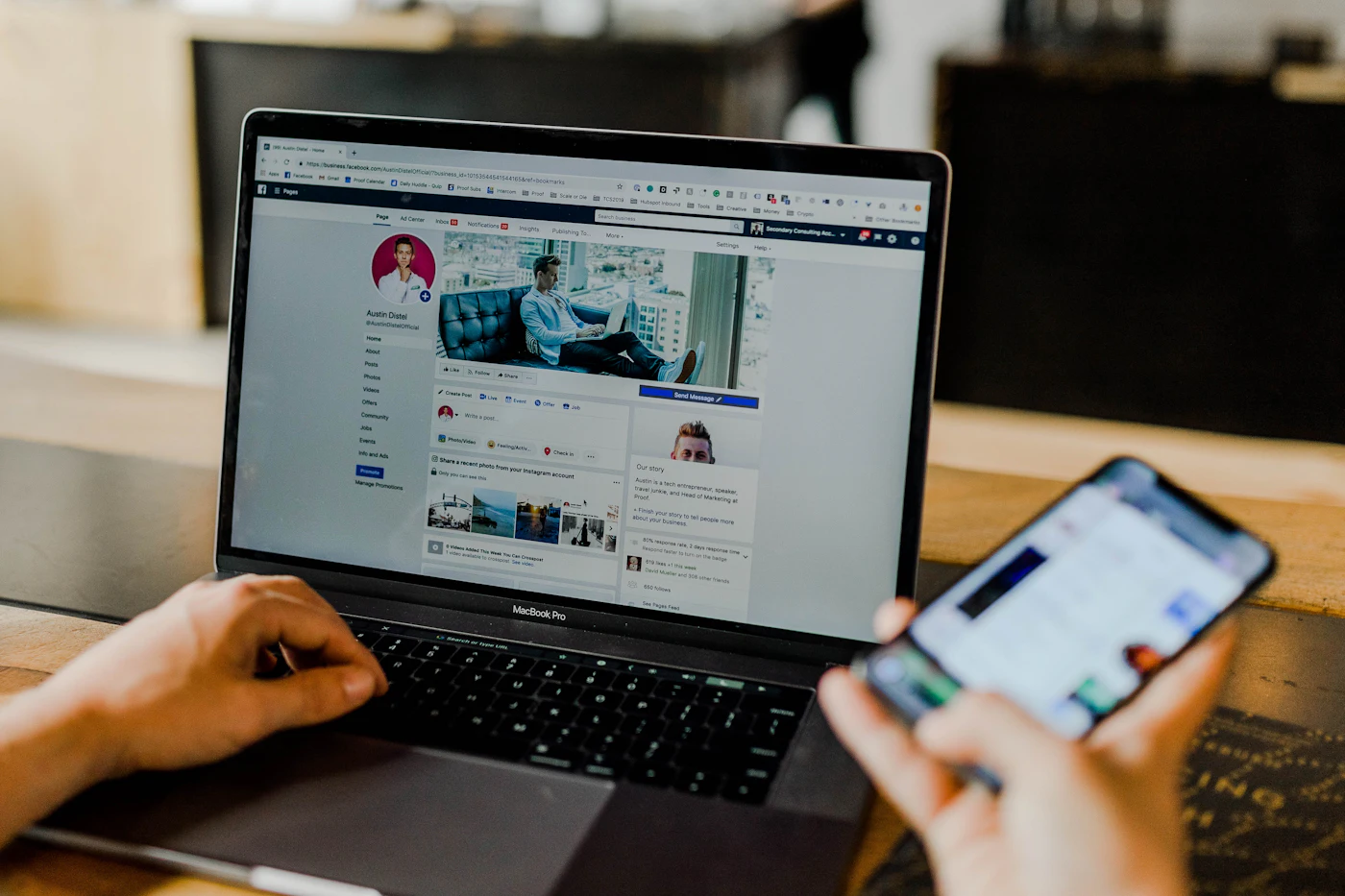 Person managing social media marketing on laptop and phone